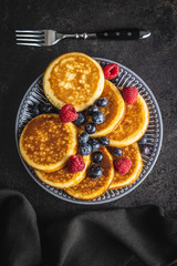 Sweet homemade pancakes with blueberries and raspberries