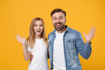 Excited bearded man in casual clothes have fun with child baby girl. Father, little kid daughter isolated on yellow orange background. Love family day, parenthood childhood concept. Spreading hands.