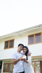 Asian couple with model house ,Happy smiling couple holding a model house. Home insurance concept