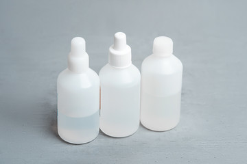 Three bottles with medicines on a gray background