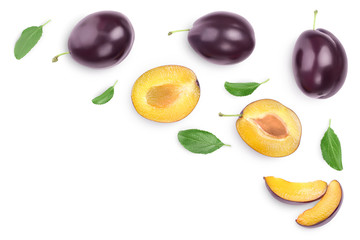 fresh purple plum and half with leaves isolated on white background with clipping path and copy spase for your text. Top view. Flat lay