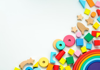Wooden toys on white background with copy space