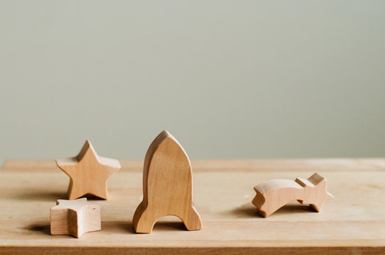 Wooden toys rocket and stars on wooden background