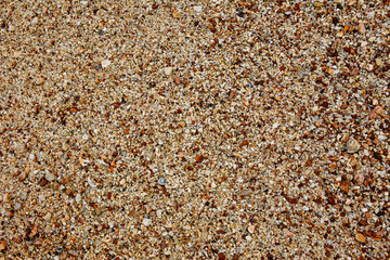 Close up of sea sand and rocks. Beach sand texture.