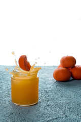 Homemade orange juice on bluish background. Copy space. Top view