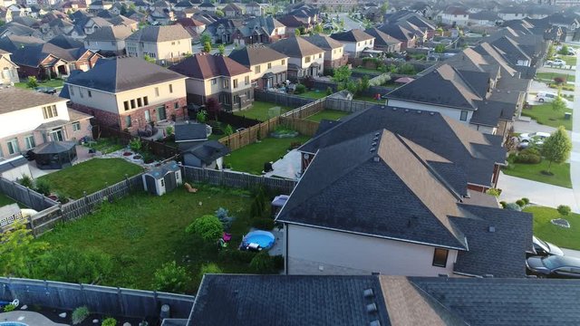 Upper Class Neighborhood Low Flying Aerial Home Rooftops Lawns Backywards Drone Aerial View Sunrise