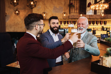  Three business people celebrating successfully done job at restaurant.