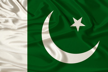 beautiful photo of the national flag of Pakistan on delicate shiny silk with soft draperies, the concept of state power, country life, horizontal, close-up, copy space