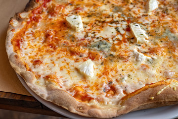 Delicious cheese pizza close-up in restaurant