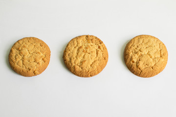 Three crispy with zest cookies on a white background