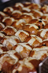 Hot cross buns made from scratch at a local bakery. Spring traditional food baked with raisins.