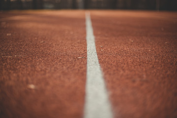 Red wall texture background. Outdoor sports. Colorful sports court background. Top view to red field rubber ground outdoors.