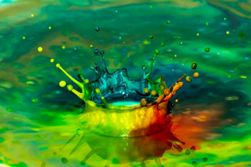 Bursts of multi-colored bright colors of paint in the form of crowns and colorful splashes