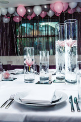 Serving tables in a restaurant with peonies and orchids