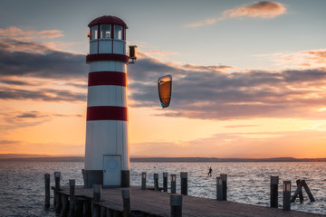 Lighthouse and Kite Surfer at Neusiedl Lake in Podersdorf, Austria at Sunset