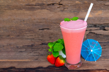 Strawberry yogurt fruit juice smoothie pink colorful fruit juice milkshake blend beverage healthy high protein the taste yummy In glass drink episode morning on wood background.
