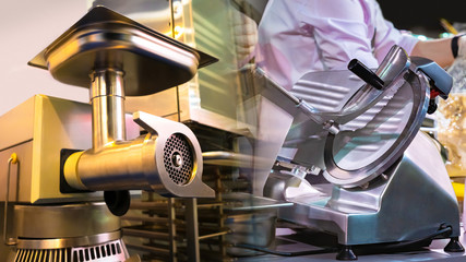 Restaurant equipment. Electric meat grinder in food production. Slicer for cutting vegetables. Professional equipment cooks. Electrical equipment for food production. Metal mincer. Slicer close up