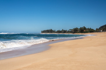 Almost deserted sandy beach at Sunset Beach park near Banzai Pipeline on north coast of Oahu, Hawaii