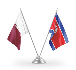 North Korea and Qatar table flags isolated on white 3D rendering