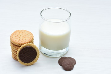 Chocolate cookies accompanied by glass of milk