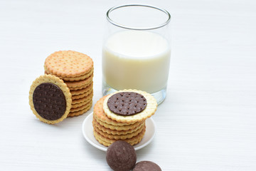 Chocolate cookies accompanied by glass of milk