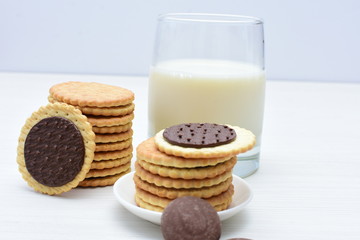 Chocolate cookies accompanied by glass of milk