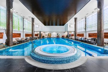 Modern blue on light backdrop. Trendy design. Water - swimming pool. Blue luxurious swimming pool in modern style on light background. Water - swimming pool. Modern design. Night club. Trendy design.