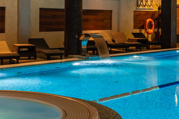 Modern blue on light backdrop. Water - swimming pool. Blue luxurious swimming pool. Swimming pool for luxury lifestyle design. Water - swimming pool. Luxury lifestyle. Natural pattern, luxury. Blue