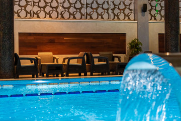 Modern blue on light backdrop. Water - swimming pool. Blue luxurious swimming pool. Swimming pool for luxury lifestyle design. Water - swimming pool. Luxury lifestyle. Natural pattern, luxury. Blue