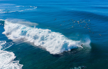 Surfers waiting for the big wave in the sea at Banzai Pipeline on north coast of Oahu, Hawaii