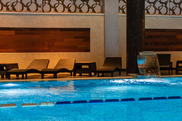 Modern blue on light backdrop. Water - swimming pool. Blue luxurious swimming pool. Swimming pool for luxury lifestyle design. Water - swimming pool. Luxury lifestyle. Natural pattern, luxury. Blue