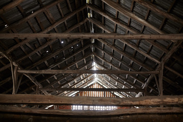 Old roof trusses covered with ceramic tile on a detached house under construction, visible roof...