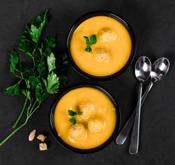 Pumpkin cream soup with meatballs on a light background