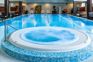 Modern blue on light backdrop. Trendy design. Water - swimming pool. Blue luxurious swimming pool in modern style on light background. Water - swimming pool. Modern design. Night club. Trendy design.
