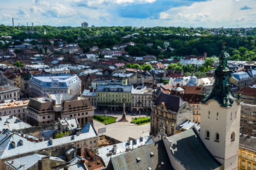 Fototapeta premium Old city vintage top view panorama with houses roofs and Latin Cathedral seen from the town hall in Lviv, Ukraine