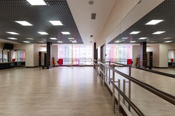 large and light hall with mirrors, music, equipment for dancing, sports. Group fitness room. Modern interior design. Fitness workout. Fitness gym background. Gym equipment background. Empty space.