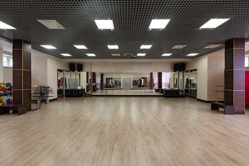 large and light hall with mirrors, music, equipment for dancing, sports. Group fitness room. Modern interior design. Fitness workout. Fitness gym background. Gym equipment background. Empty space.