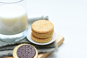 Fototapeta na wymiar Chocolate cookies accompanied by glass of milk