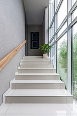 Obraz premium Green staircase window in modern style on white background. Interior design wall. Modern interior design. Modern stylish apartment. Concrete wall. Bright interior.