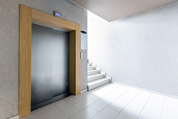 Luxury lifestyle design. Modern interior design. Modern steel elevator. Stairs. Nobody inside.