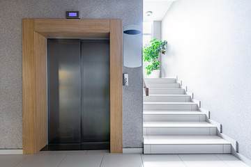 Luxury lifestyle design. Modern interior design. Modern steel elevator. Stairs. Nobody inside.