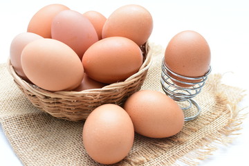 Peasant chicken eggs on light background