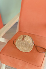 Wicker handmade bag on the armchair. Concept of the vacation