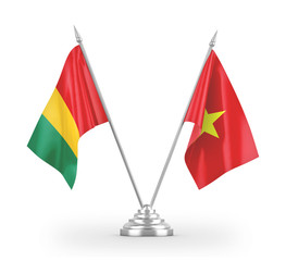 Vietnam and Guinea table flags isolated on white 3D rendering