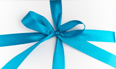 festive white gift box with blue bow
