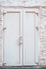 Front exterior white doors of old brick building