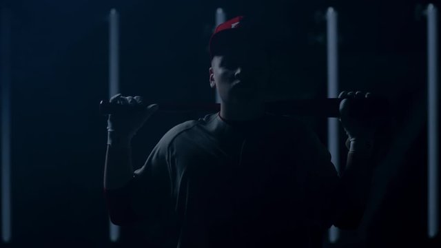 Caucasian professional baseball player batter posing against bright lights. 4K UHD 60 FPS SLOW MOTION shot on ARRI Alexa Mini with Cooke S4 lens