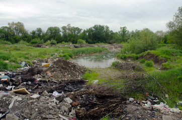 Polluted field with illegal trash dump