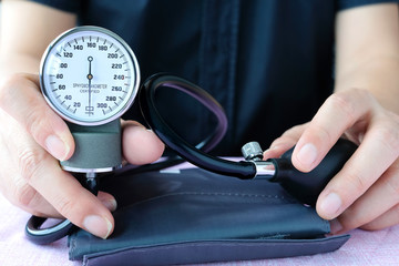 Man check blood pressure monitor and heart rate monitor with digital pressure gauge. Health care and Medical concept