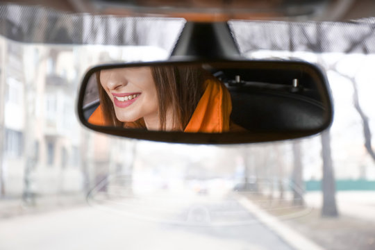 Reflection Of Driver In Car Rear View Mirror